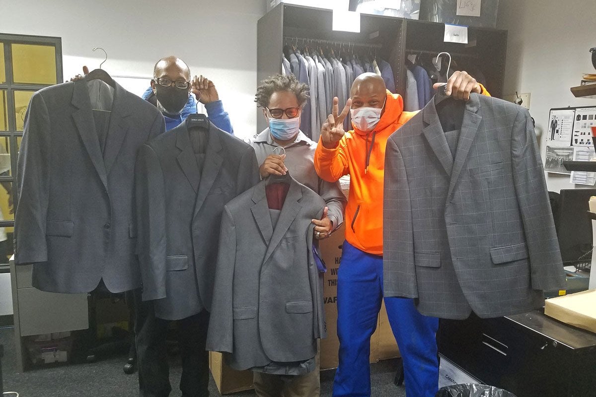 Receiving the shippment of Alex Trebek’s suits in NYC are Michael Smith, Joseph Calhoun, George Thomas of the Ready, Willing & Able program established by The Doe Fund.