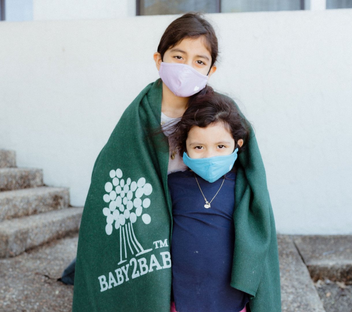 2 sisters wearing masks